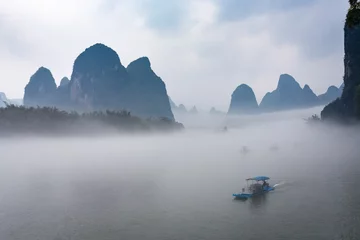 Tuinposter view of fog with ships on river near Xingping town © vvoe
