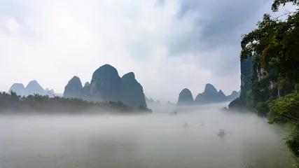 Gordijnen panoramic view of fog over river near Xingping © vvoe