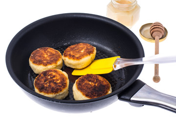 Fried cheese cakes in frying pan