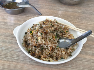 dish with with rice with fried eggs on table