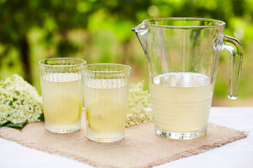 Two glasses and a jug of elderflower lemonade