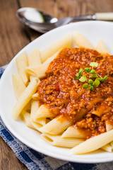 Pasta penne with tomato bolognese sauce.