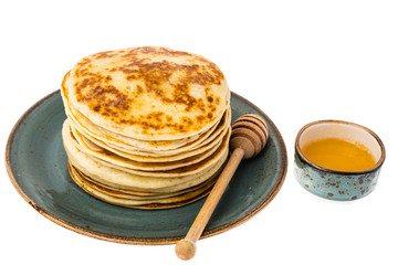 Stack of fried vanilla pancakes on plate on white background