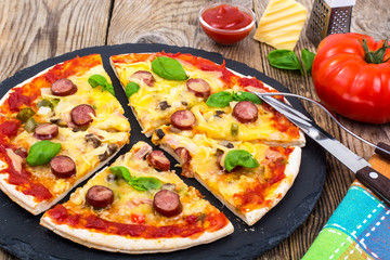 Crispy hot pizza on old wooden table