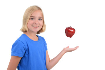child tossing apple up in air white background