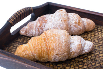 Croissants on wooden tray