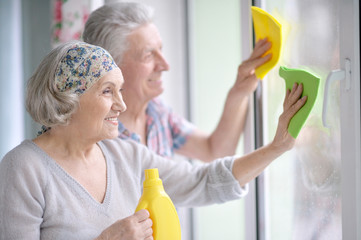 couple washing windows together