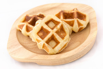 Small waffles on wood dish