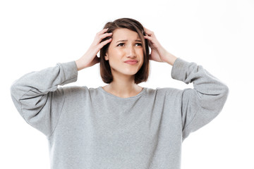 Young confused woman keeping her hands on head