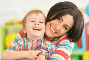 Young mother playing with son