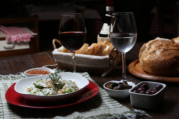 Italian dinner with breads, water and wine, table tidy