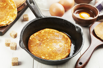 Homemade pancake in the frying pan on the table