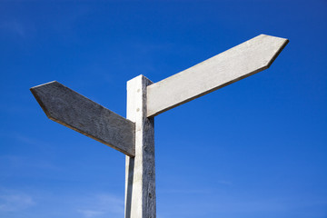 empty wooden signboard against blue sky