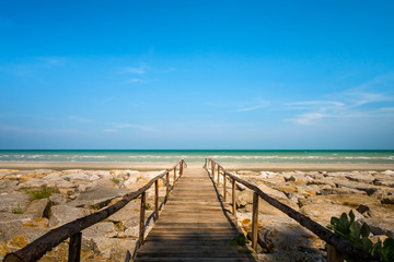 Wooden bridge walkway to the sea beach