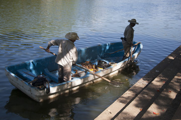 Two man on boat. Lagoon of illusions, Tomas Garrido Canabal Park, Villahermosa, Tabasco, Mexico.