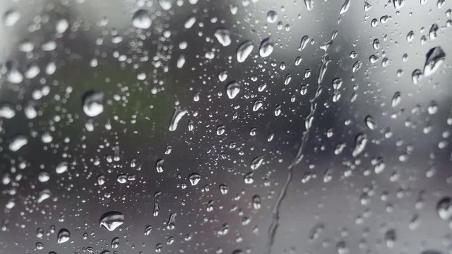 Rain falling on glass during rain storm. 4k, 3840x2160