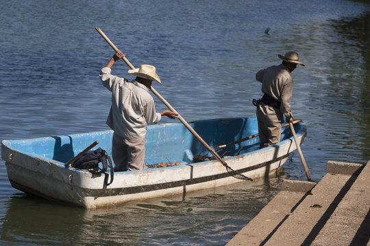 Two man on boat. Lagoon of illusions, Tomas Garrido Canabal Park, Villahermosa, Tabasco, Mexico.	