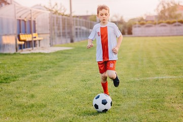 8 years old boy child playing football