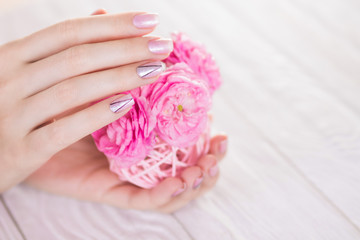 Beautiful pink manicure with silver triangles