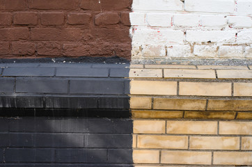 Multicolored old brick wall background. Black, white, brown and yellow mosonry texture