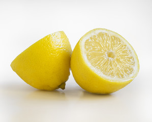 Some yellow, ripe and fresh lemons are on the white background.