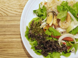 Spicy seafood noodle salad, closeup.