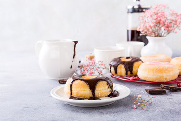 Homemade doughnuts with chocolate glaze on light gray background. Selective focus. Copy space.