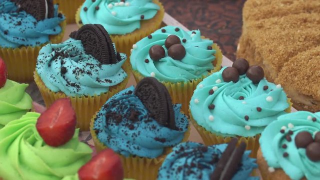 Cupcakes with colorful cream served on the table