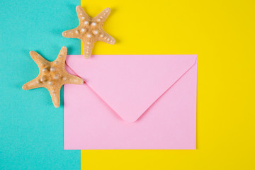 Pink envelope with two starfishes on colored backgrounds with negative space