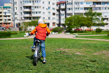 Small boy ride bicycle in street park.