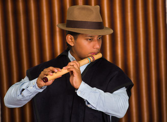 Young man from Otavalo, Ecuador, playing the quena flute © Fotos 593