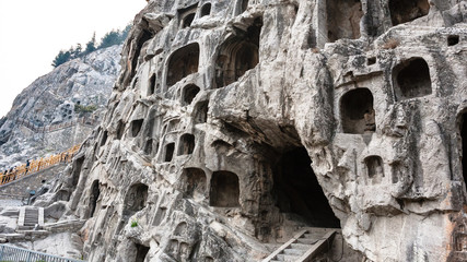 visitors near caves in slope of West Hill
