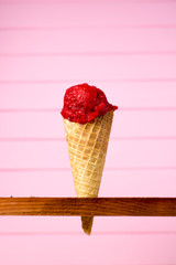 Ice cream with a ball in a waffle cup strawberry