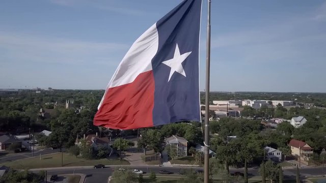 Texas Flag Waving while aerial camera orbits