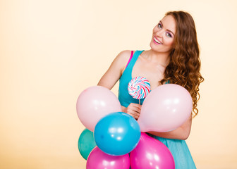 Woman with colorful balloons and lollipop