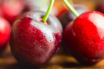 Fresh and wet cherry berries with water drops, macro image, selective focus
