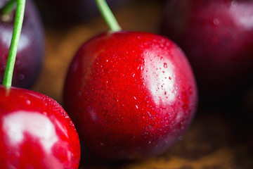 Fresh and wet cherry berries with water drops, macro image, selective focus