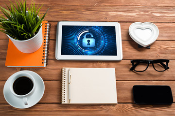 Web security and technology concept with tablet pc on wooden table
