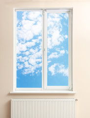 View of blue sky through modern window in room