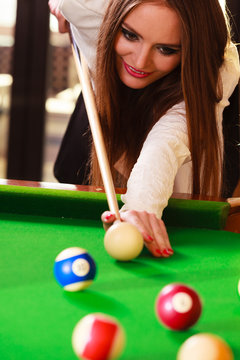 Young woman having fun with billiard.