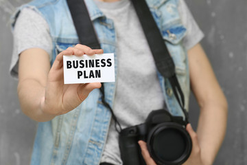 Female photographer with business card, closeup