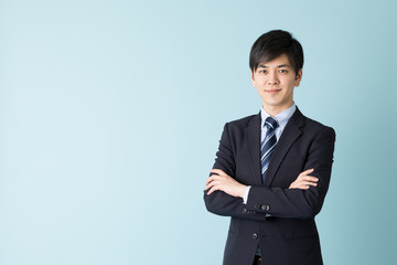 portrait of asian businessman isolated on blue background