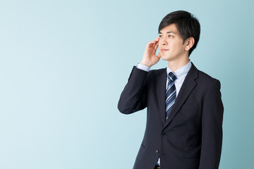 portrait of asian businessman isolated on blue background