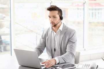 Handsome young man working in office © Africa Studio