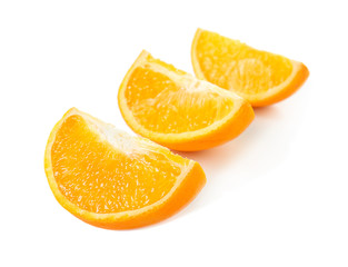 Slices of delicious orange on white background