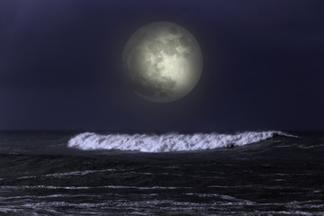 Naklejka na ściany i meble Sea wave in a dark full moon night