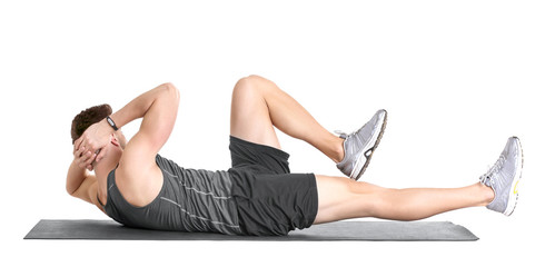 Handsome man doing bicycle crunch on white background