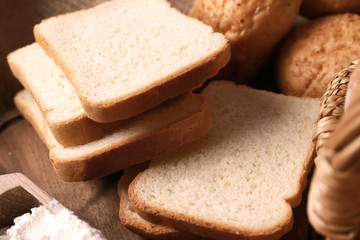 Delicious sliced bread on table, closeup