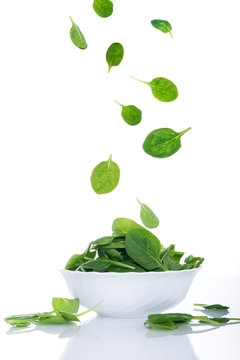 Food in motion, spinach leaves flying