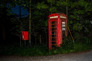 red phone box at night england